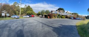 Lyonville's closed Radio Springs Hotel. Poorly marked trail entrance in background [2024]
